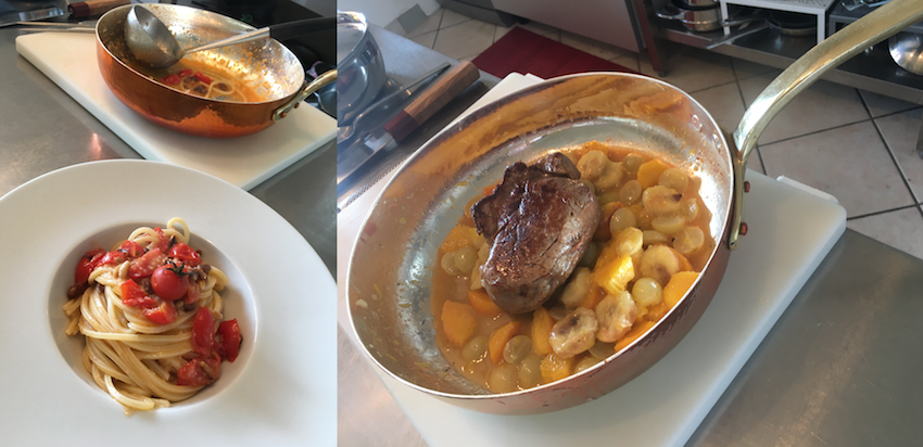 Un piatto con dei semplici spaghettoni ed una preparazione creativa di filetto di manzo su frutta, la casseruola di rame ancora in azione.